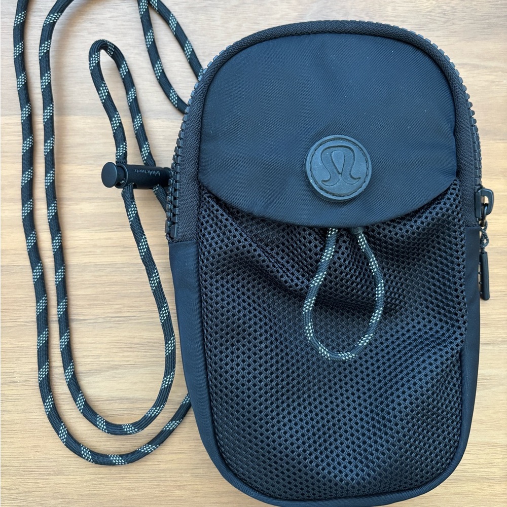 Slightly used Lululemon mini crossbody bag in the color black.